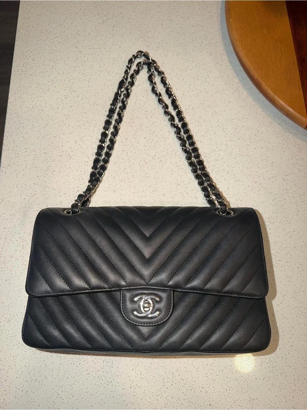 CHANEL Black Leather Interior with Silver Logo Plaque